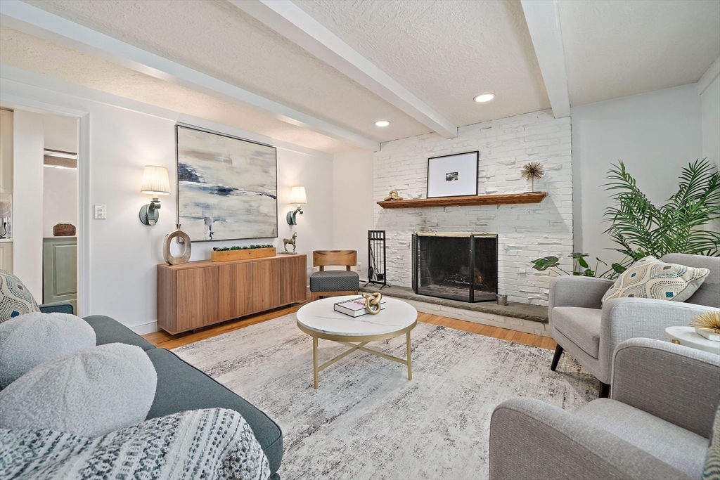 6 Garfield Street Lexington, MA 02421 - Photo 7 of 40 a living room with furniture a fireplace and a table