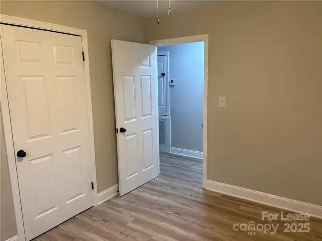 an empty room with wooden floor