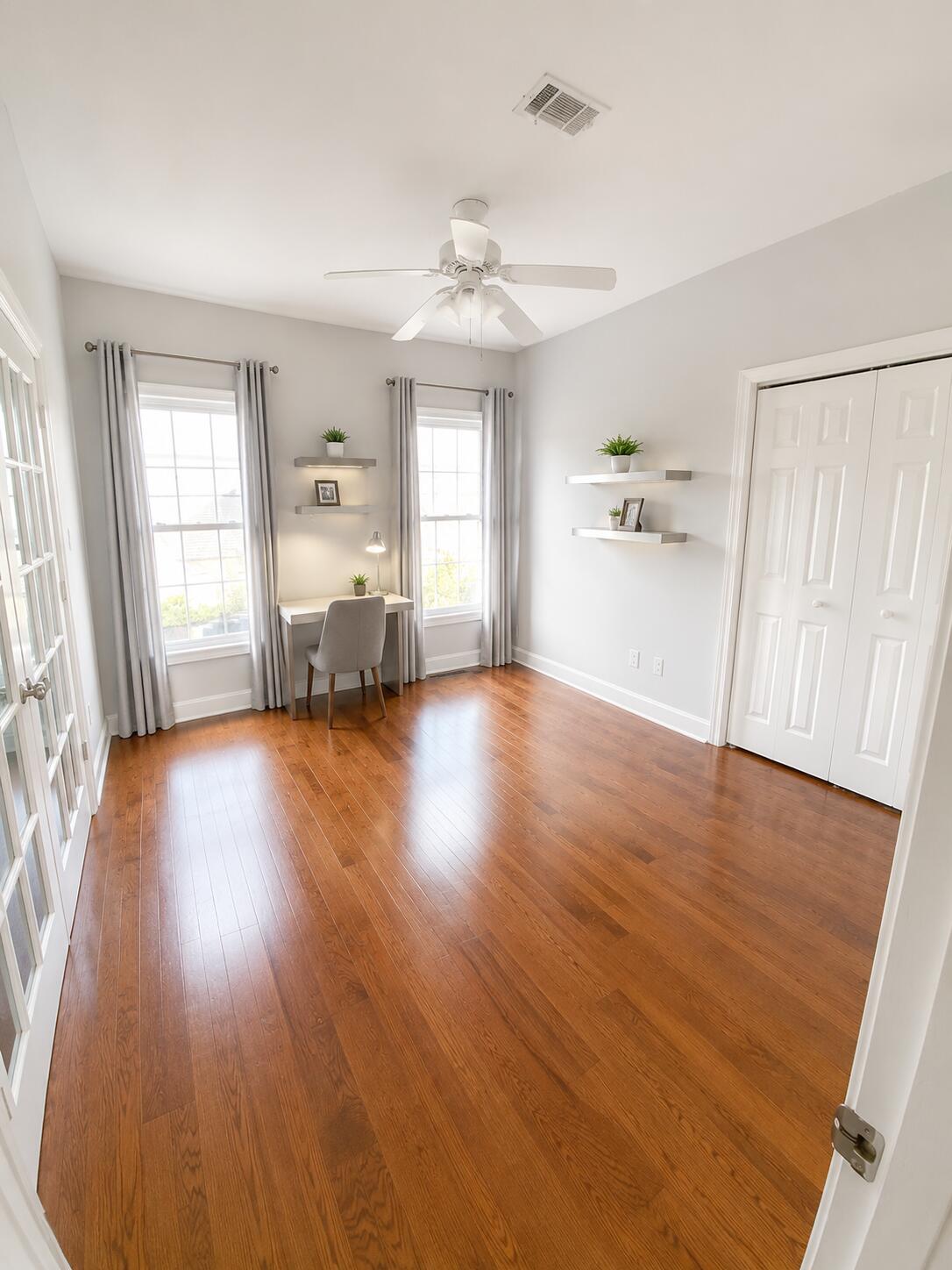 147 Dover Lane Freeport, FL 32439 - Photo 13 of 27 a view of a livingroom with furniture wooden floor ceiling fan and windows