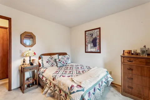 a bedroom with two beds and a window