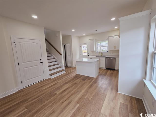 Tbd 67th Avenue North Myrtle Beach, SC 29572 - Photo 22 of 31 Kitchen featuring a center island, light countertops, white cabinets, a sink, and dishwasher