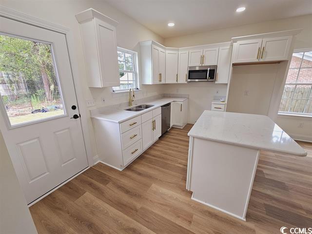 Tbd 67th Avenue North Myrtle Beach, SC 29572 - Photo 23 of 31 Kitchen with white cabinets, a center island, stainless steel appliances, light countertops, and a sink