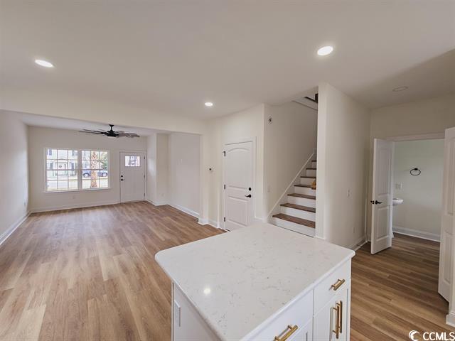 Tbd 67th Avenue North Myrtle Beach, SC 29572 - Photo 31 of 31 Kitchen with open floor plan, light countertops, a kitchen island, and white cabinetry