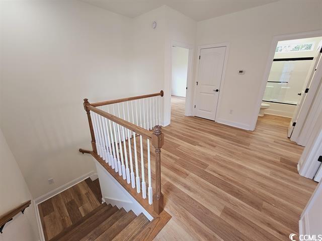 Tbd 67th Avenue North Myrtle Beach, SC 29572 - Photo 24 of 31 Stairs featuring baseboards and wood finished floors