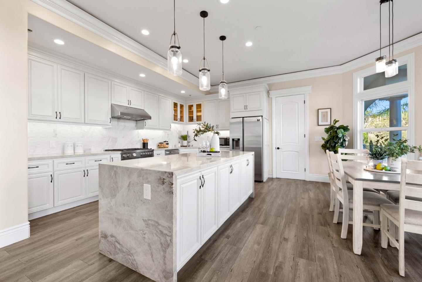 20394 Almaden Road San Jose, CA 95120 - Photo 13 of 92 a kitchen with stainless steel appliances kitchen island granite countertop a stove a sink a refrigerator and white cabinets with wooden floor