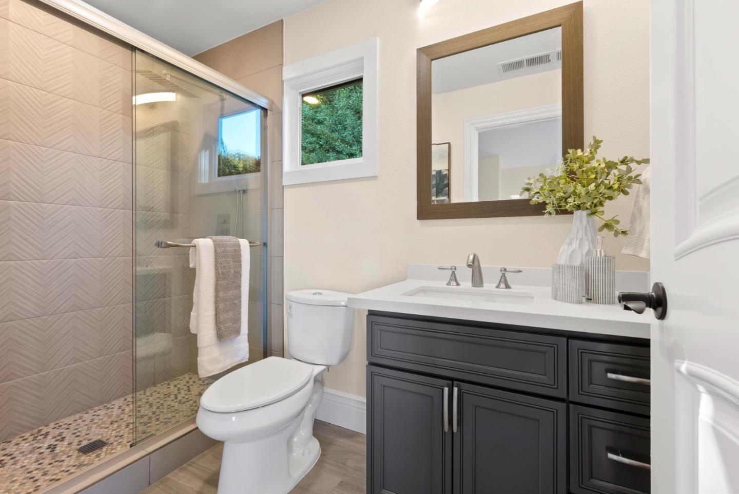20394 Almaden Road San Jose, CA 95120 - Photo 54 of 92 a bathroom with a granite countertop sink toilet and mirror