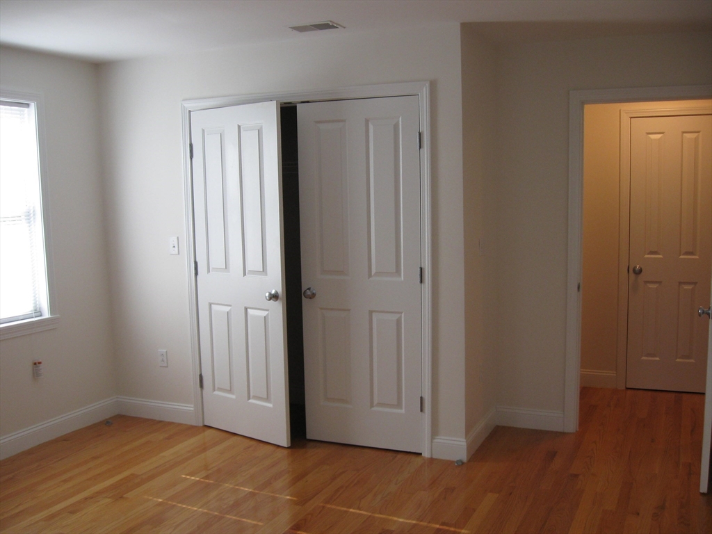 2856 Washington Street Boston, MA 02119 - Photo 16 of 39 an empty room with wooden floor