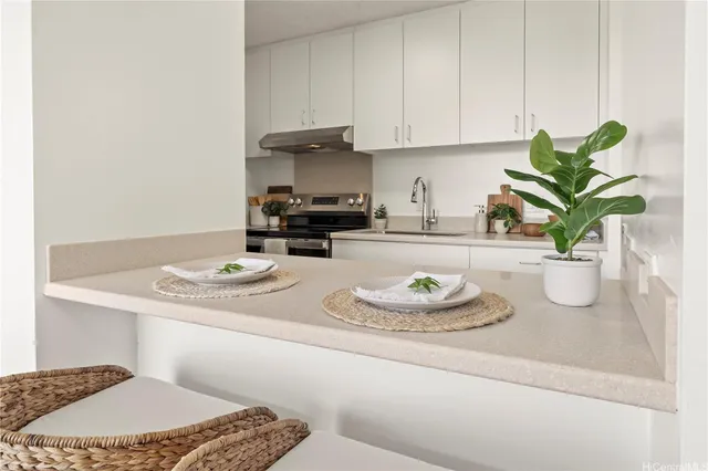 a kitchen with a sink a stove and cabinets
