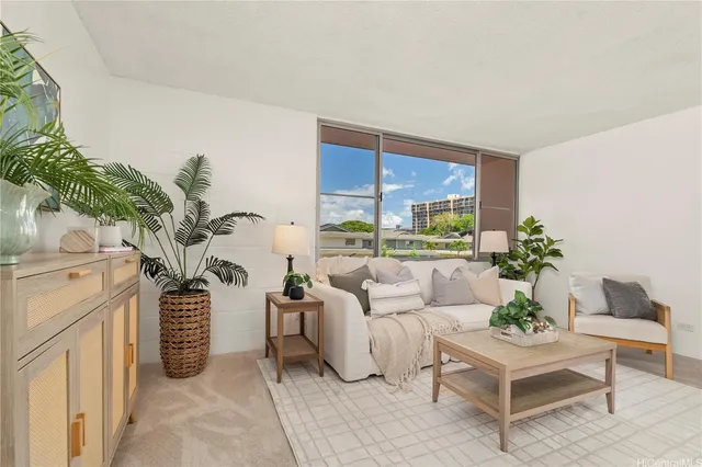 a living room with furniture a chandelier and a potted plant