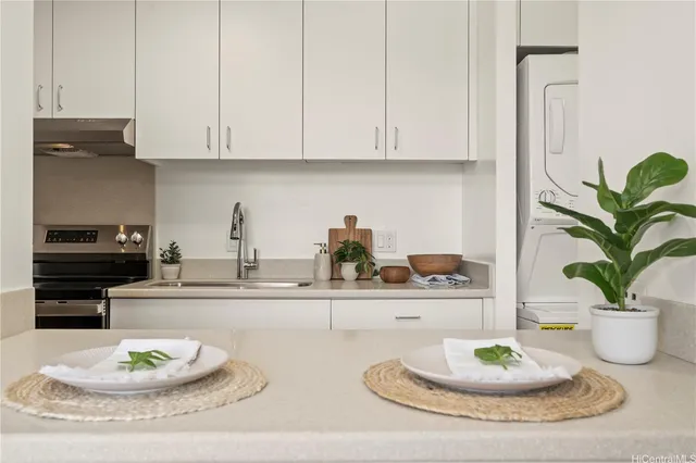 a kitchen with a table and a potted plant