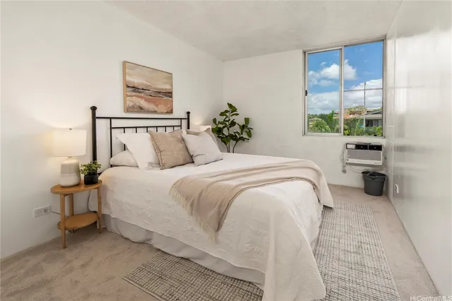 a bedroom with a bed and a painting on the wall