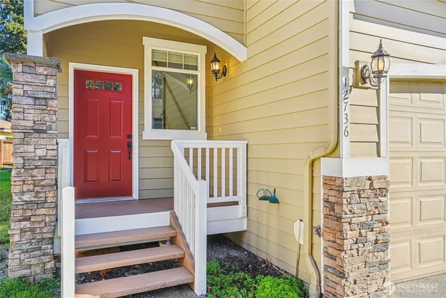 a front view of a house with a garden