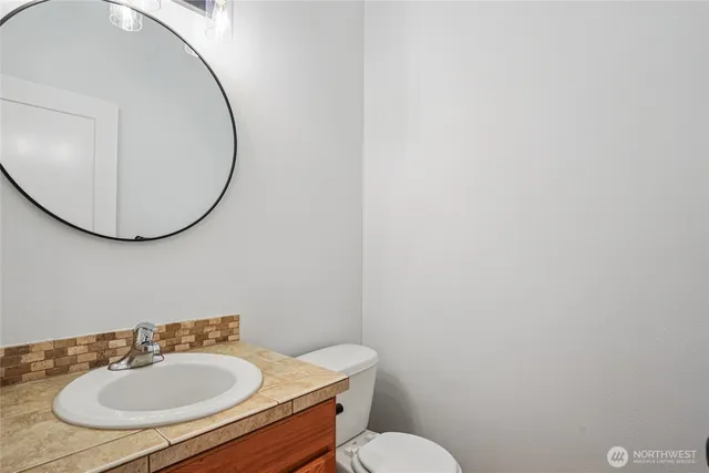 a bathroom with a sink a mirror and a toilet