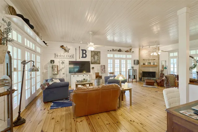 a living room with fireplace furniture and a wooden floor