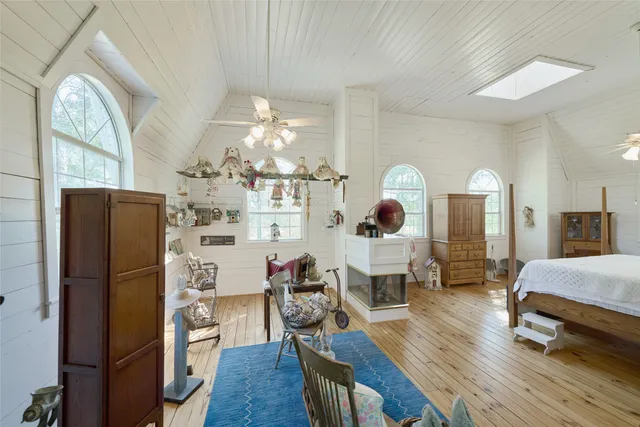a living room with furniture a fireplace and a chandelier