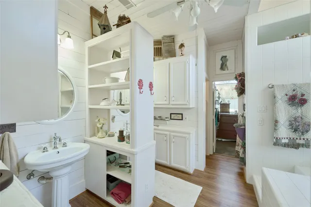 a bathroom with a sink a toilet and shower curtain