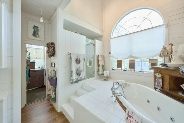 a view of a house with brick walls and a yard with plants