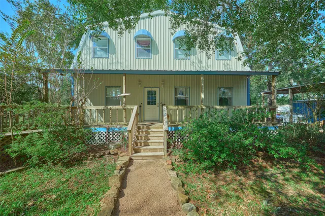 a living room with lots of furniture and wooden floor