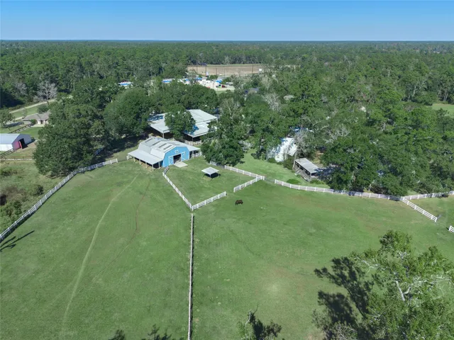 an aerial view of a house with a yard