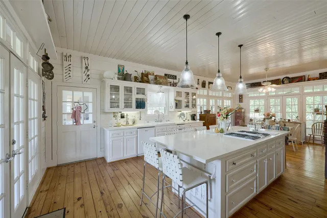 a kitchen with counter top space and wooden floor