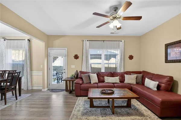 a living room with furniture a table and a large window