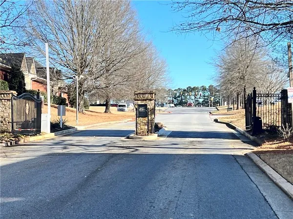 a view of a yard with trees on the road