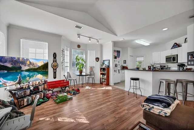 a living room with furniture and wooden floor