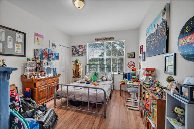a view of a room with wooden floor and bench
