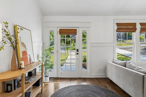 a view of an entryway with wooden floor and windows
