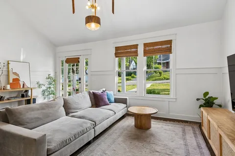 a living room with furniture and a potted plant