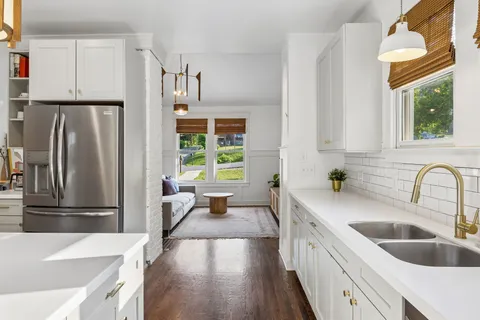 a kitchen with stainless steel appliances a refrigerator sink and cabinets