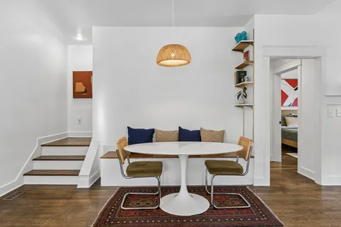 a bedroom with a bed and a painting on the wall