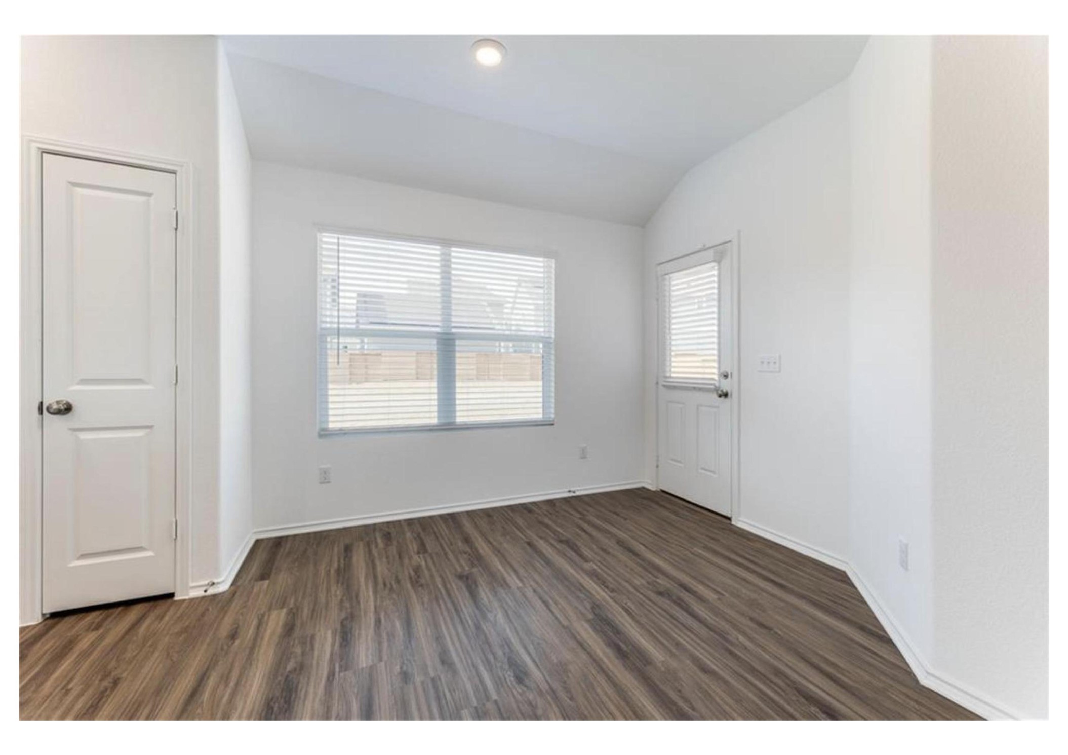 381 Jack Ryan Kyle, TX 78640 - Photo 16 of 25 A well-lit area showcasing durable wood flooring and ample natural light.