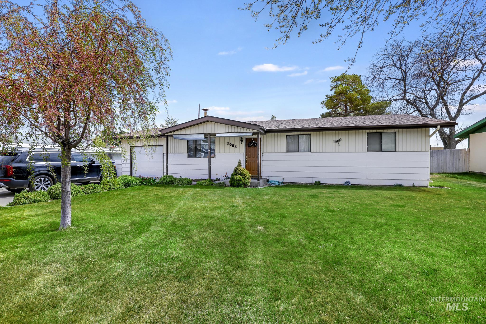 1055 South Adell Street Filer, ID 83328 - Photo 1 of 1 Single story home with a front yard, a shingled roof, and an attached garage