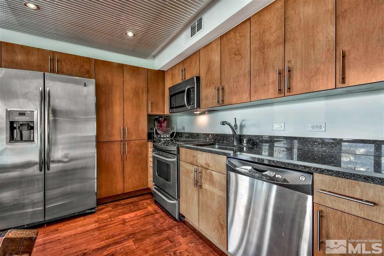 255 North Sierra Street Reno, NV 89501 - Photo 6 of 17 a kitchen with stainless steel appliances granite countertop a refrigerator a sink and a stove