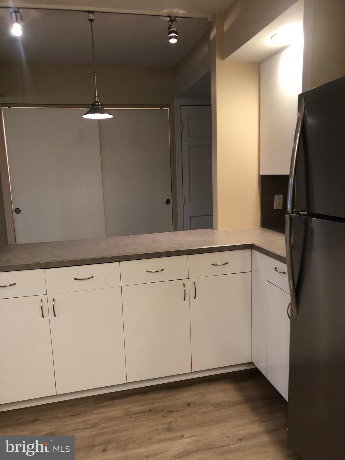 1600 Hagys Ford Road, Unit 2P Penn Valley, PA 19072 - Photo 11 of 15 a kitchen with a refrigerator and cabinets