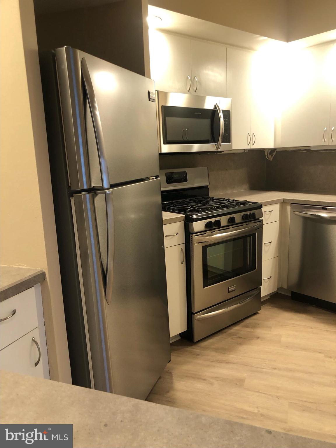 1600 Hagys Ford Road, Unit 2P Penn Valley, PA 19072 - Photo 13 of 15 a metallic refrigerator freezer sitting in a kitchen