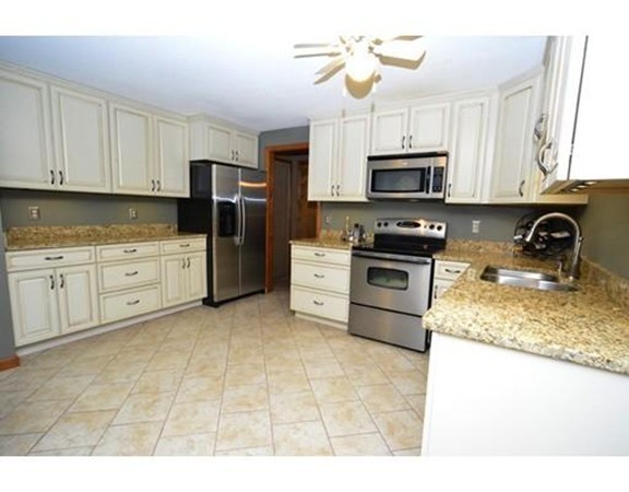 556 Burts Pit Road Northampton, MA 01062 - Photo 12 of 24 a kitchen with stainless steel appliances granite countertop a stove a sink dishwasher a refrigerator and a microwave