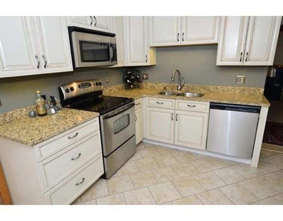 556 Burts Pit Road Northampton, MA 01062 - Photo 15 of 24 a kitchen with granite countertop white cabinets stainless steel appliances and a sink
