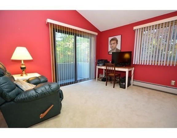 556 Burts Pit Road Northampton, MA 01062 - Photo 19 of 24 a bedroom with a bed and a flat screen tv