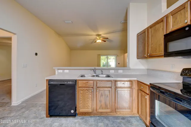 a kitchen with a sink stove and microwave