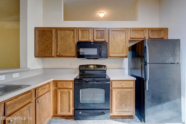 a kitchen with a refrigerator stove and microwave
