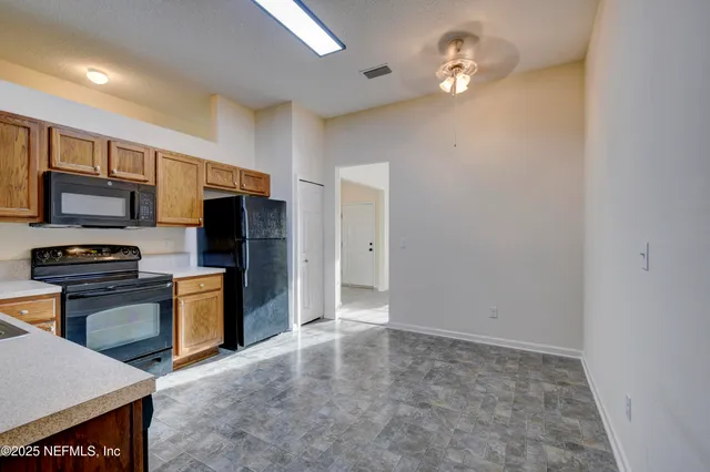 a view of a kitchen with a sink and stainless steel appliances