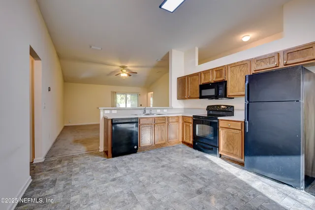 a kitchen with a refrigerator sink and stove