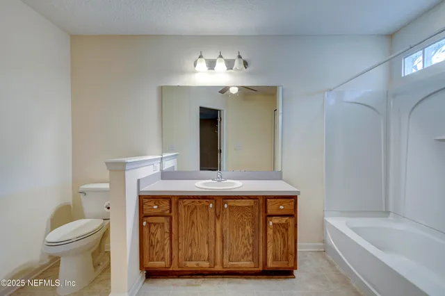 a bathroom with a sink a toilet and bathtub