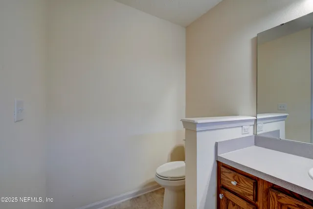 a bathroom with a sink a toilet and vanity
