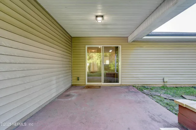 a view of a backyard with table and chairs and a large tree