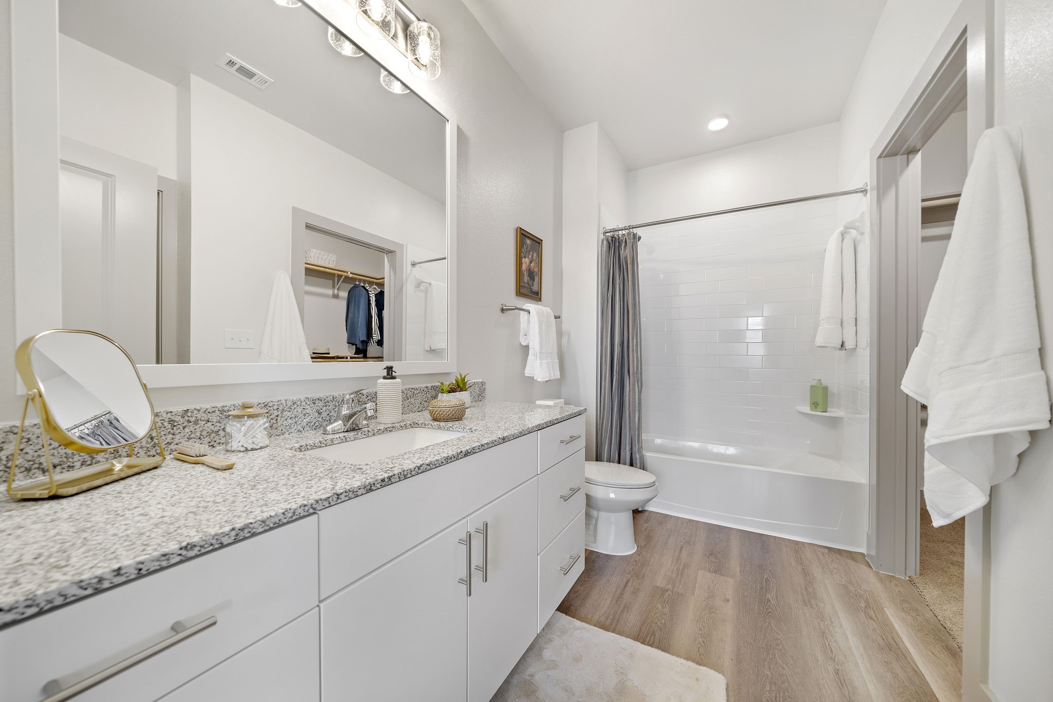 10485 League Line Road, Unit 1201 Conroe, TX 77304 - Photo 6 of 10 a bathroom with a granite countertop sink mirror toilet and bathtub