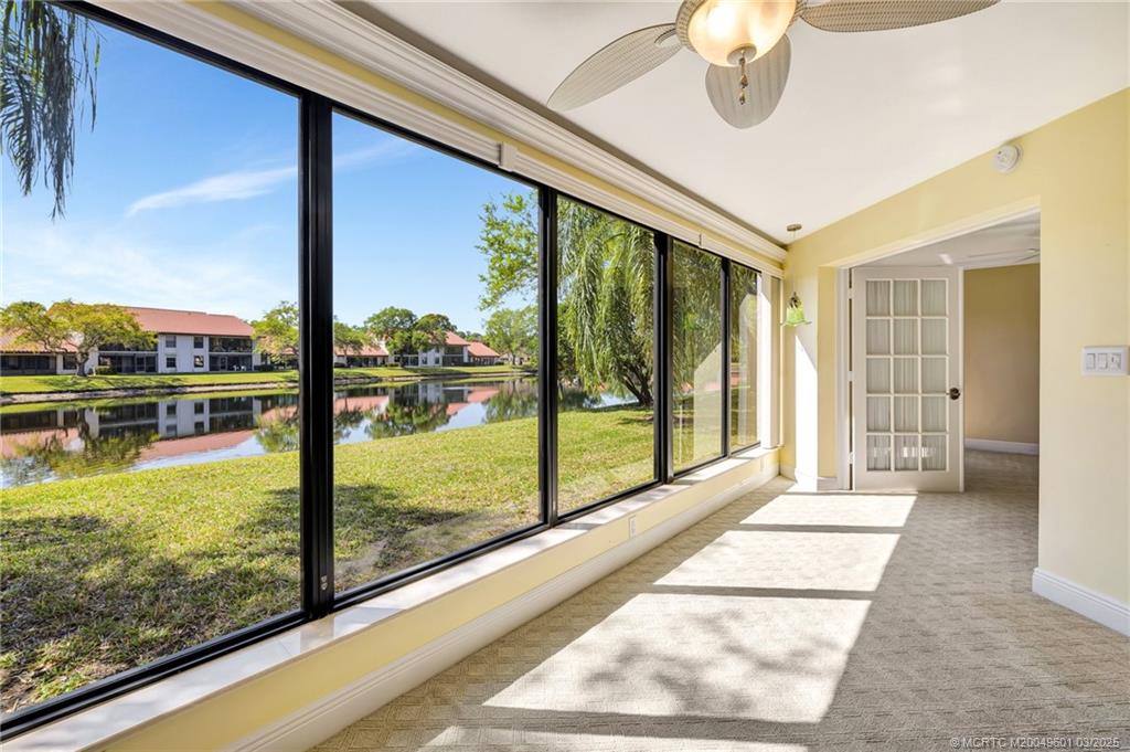 6040 Southeast Martinique Drive, Unit 102 Stuart, FL 34997 - Photo 19 of 52 a view of a living room and floor to ceiling window