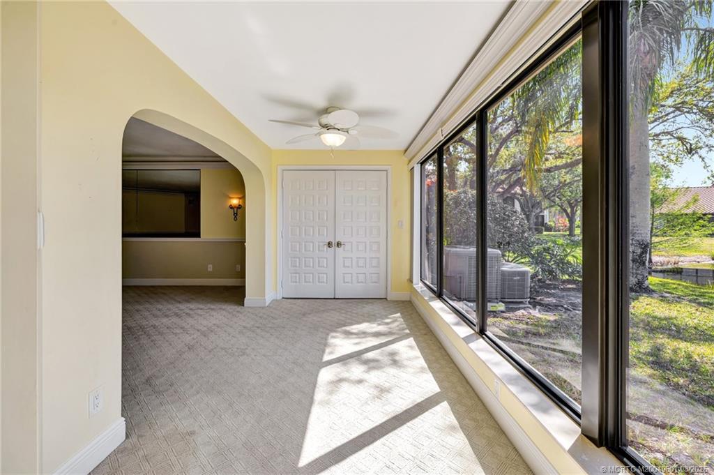 6040 Southeast Martinique Drive, Unit 102 Stuart, FL 34997 - Photo 20 of 52 a view of a hallway with wooden floor and windows